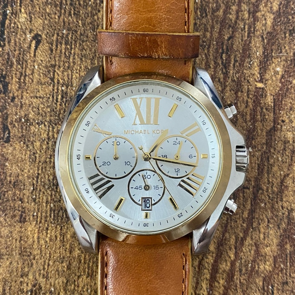 Sleek Michael Kors leather band watch.